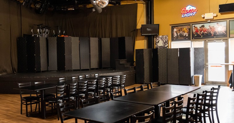 Interior, the stage, tables, chairs, lights, glass doors