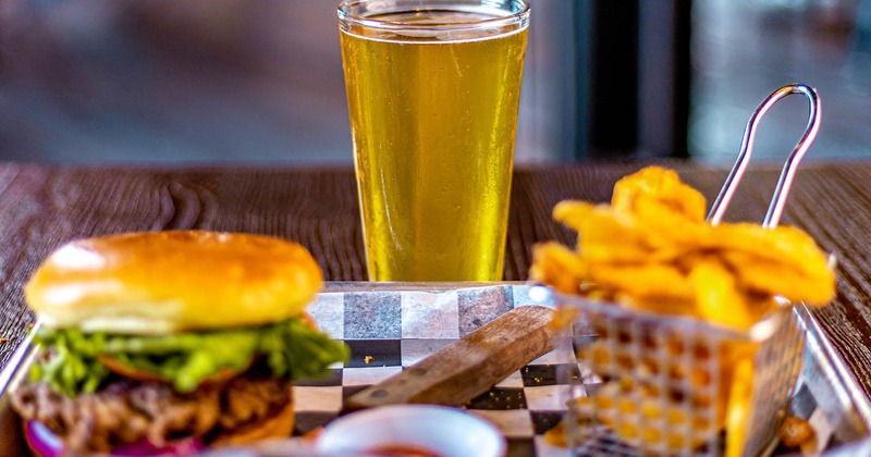 Cheeseburger served with beer