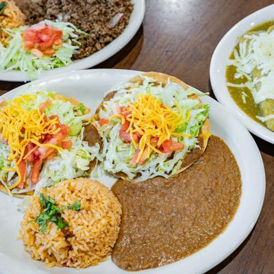 Bean and cheese chalupas served with refried beans, rice, and other Mexican dishes.