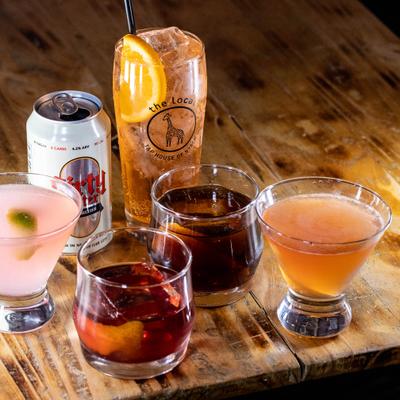 Assorted drinks on a wooden table.