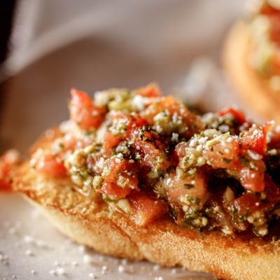 Bruschetta with diced tomatoes, parmesan cheese, basil and fresh garlic.