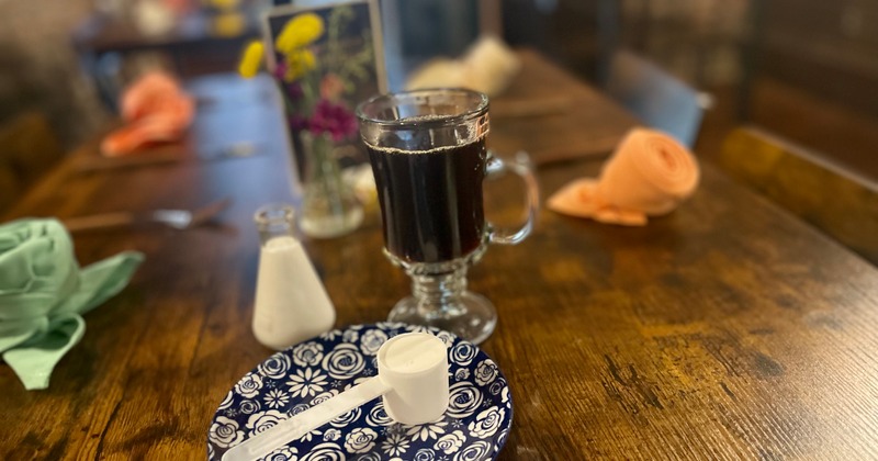 Coffee and a scoop of collagen served on table inside
