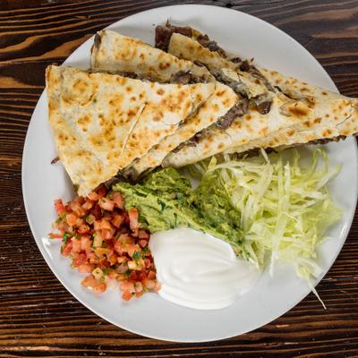 Kennett quesadilla served with guacamole, sour cream, shredded lettuce and pico de gallo.