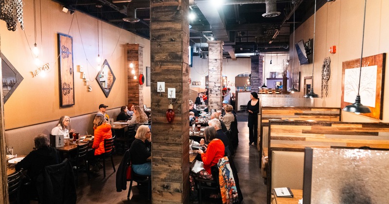 Spacious and cozy interior dining area full of guests enjoying their food and drinks