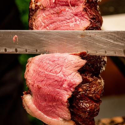 Cutting BBQ meat from rotisserie