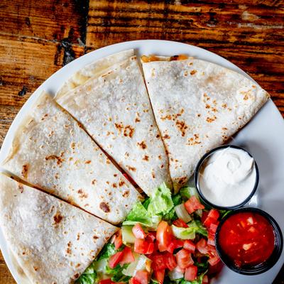 Quesadilla served with salsa, sour cream and salad.
