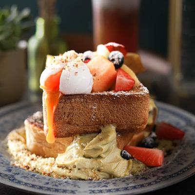 French toast with coconut pandan jam, fresh fruit, and a poached egg.