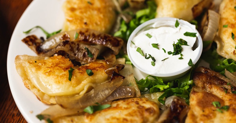 Pierogi dumplings, with parsley and dipping sauce