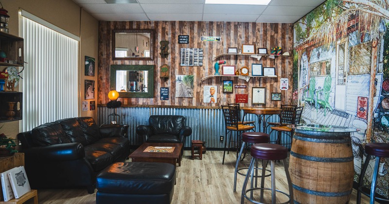 Lounge area, leather sofa set and tables with barstools