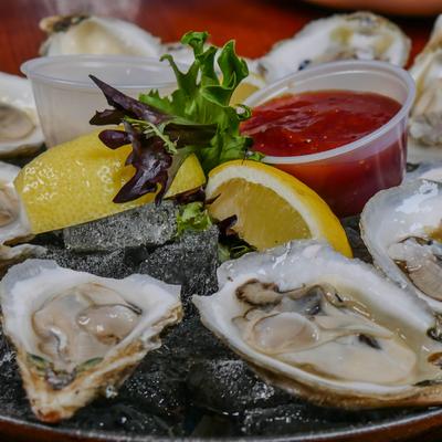 Oysters on the half shell with lemon, cocktail sauce, and horseradish.
