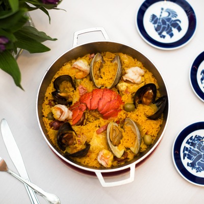 Clams, mussels, lobster, olives and yellow rice dish, top view