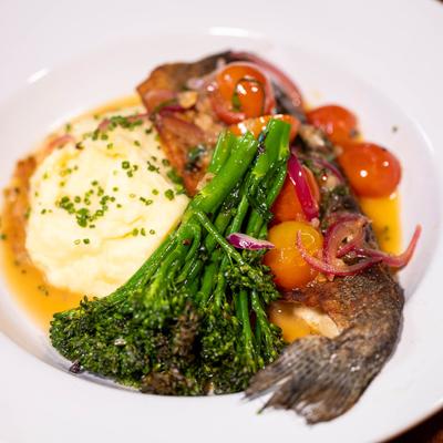 Pan Seared Trout with cherry tomatoes, white wine, mashed potatoes, & broccolini.