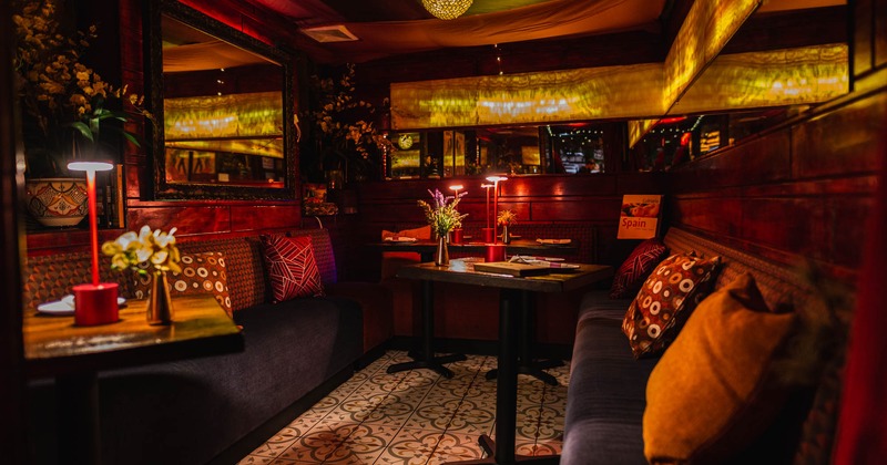 Interior, dining tables and banquette seating with pillows