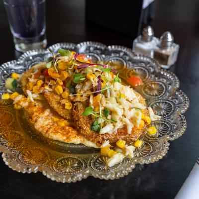 Appetizer featuring fried green tomatoes topped with lump crab.