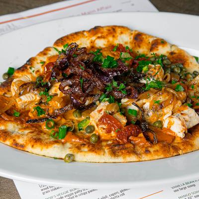 Naan bread topped with grilled chicken, caramelized onions, capers, and sun-dried tomatoes.