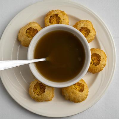 Pani Puri served with masala water.