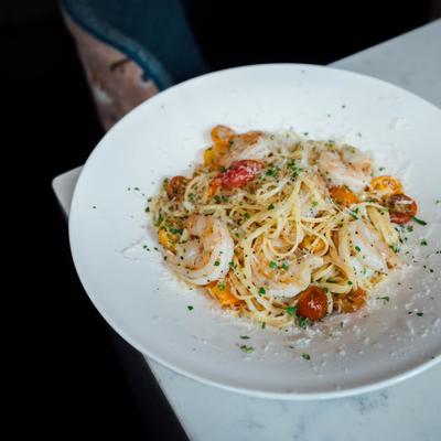Spaghetti with shrimps, cherry tomatoes, grated parmesan
