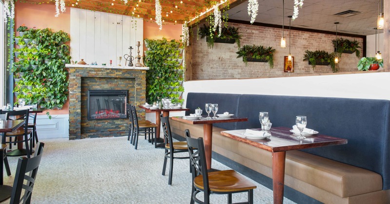 Interior, long banquette seating, tables, chairs, fireplace