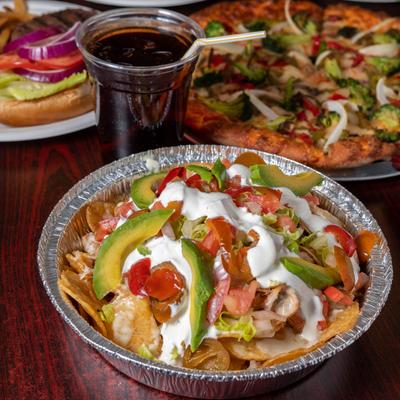 Rubbin Butts Nachos, cup of coke, burger and fries, and  The Veggie Lover pizza.