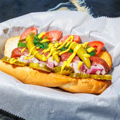 Chicago dog topped with mustard, onions,  green relish, tomato and sport peppers.