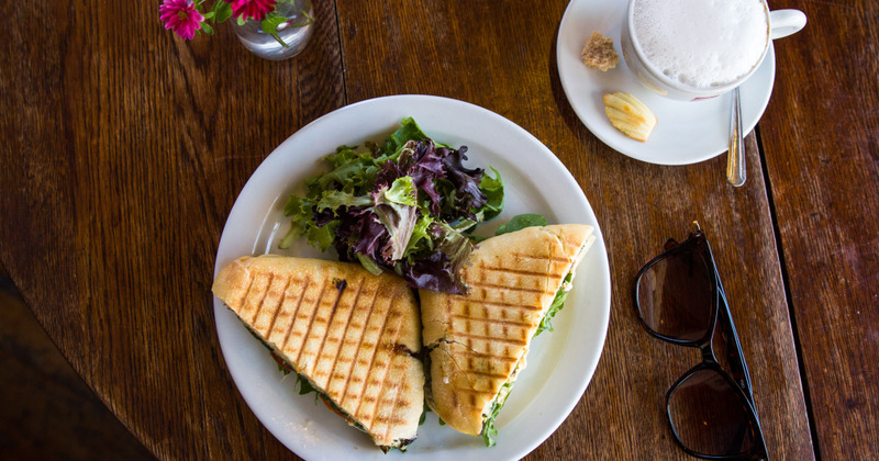 Sandwich cut in half served with coffee, top view