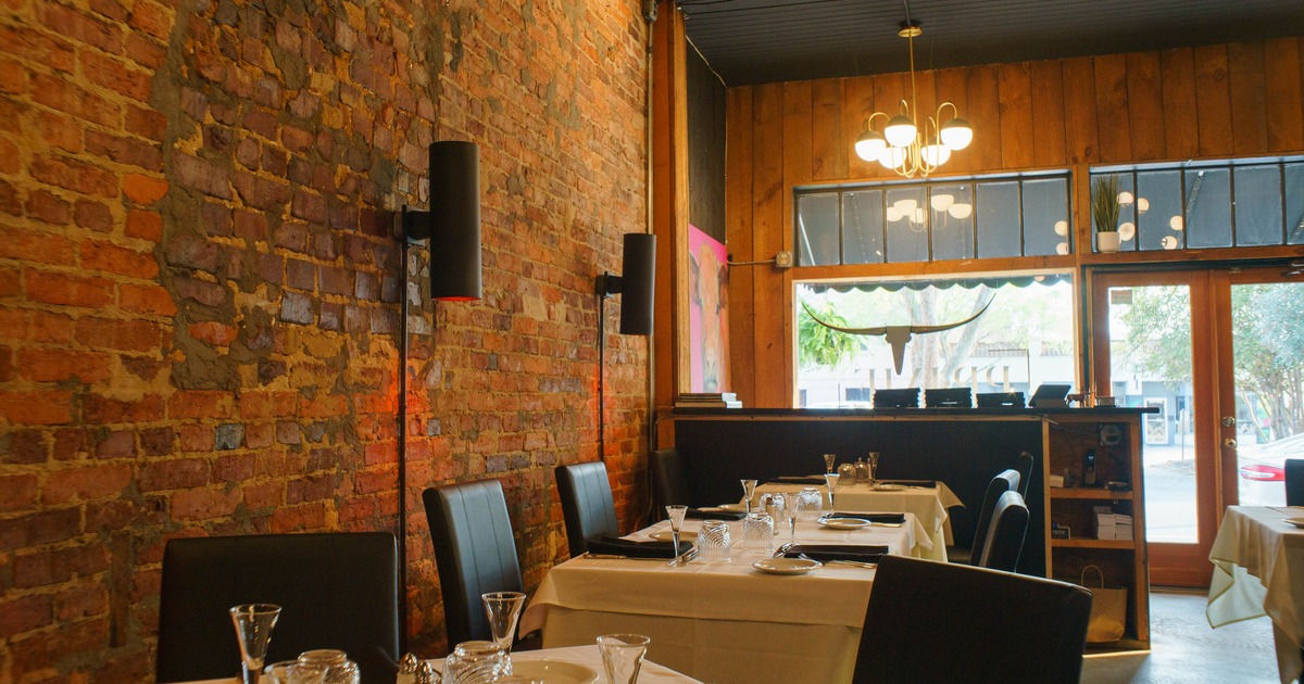 Interior, white cloth tables, ready for guests, restaurant entrance, shop window
