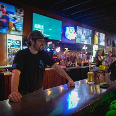 employee behind bar.