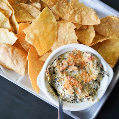 Spinach and artichoke dip with tortilla chips.