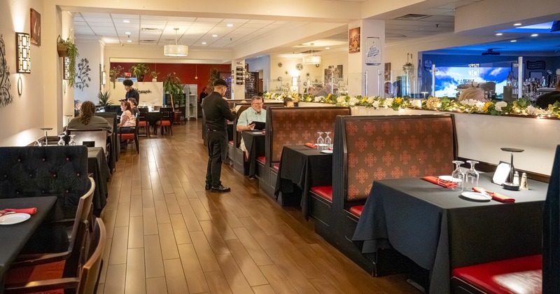 Cozy interior dining area with upholstered dining booths set for guests