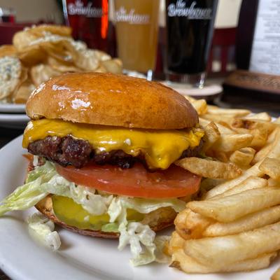 Brewhouse Burger with Cheese  tomato  lettuce and fries.