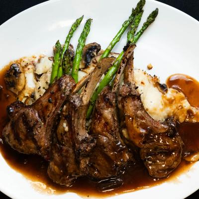 Lamb chops served with asparagus and mashed potatoes, mushroom sauce.