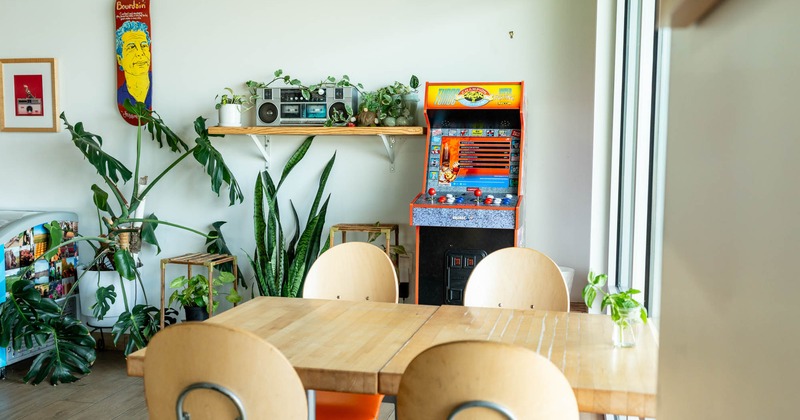 Interior, dining area, corner seating, arcade game, potted plants as decoration