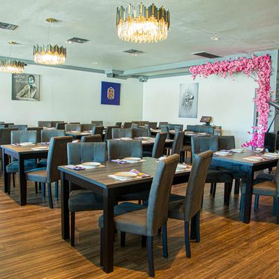 Seating area featuring set dining tables and chairs.