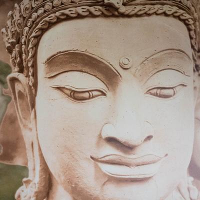 Buddha face artwork in neutral tones.