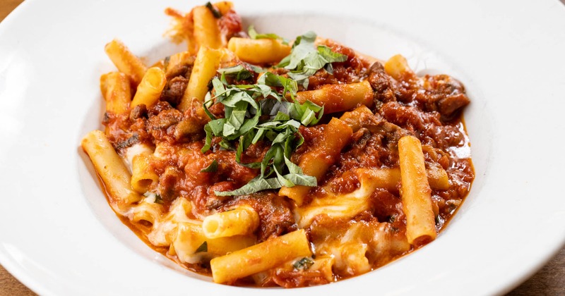 Pasta with mozzarella, eggplant, and basil in a tomato sauce