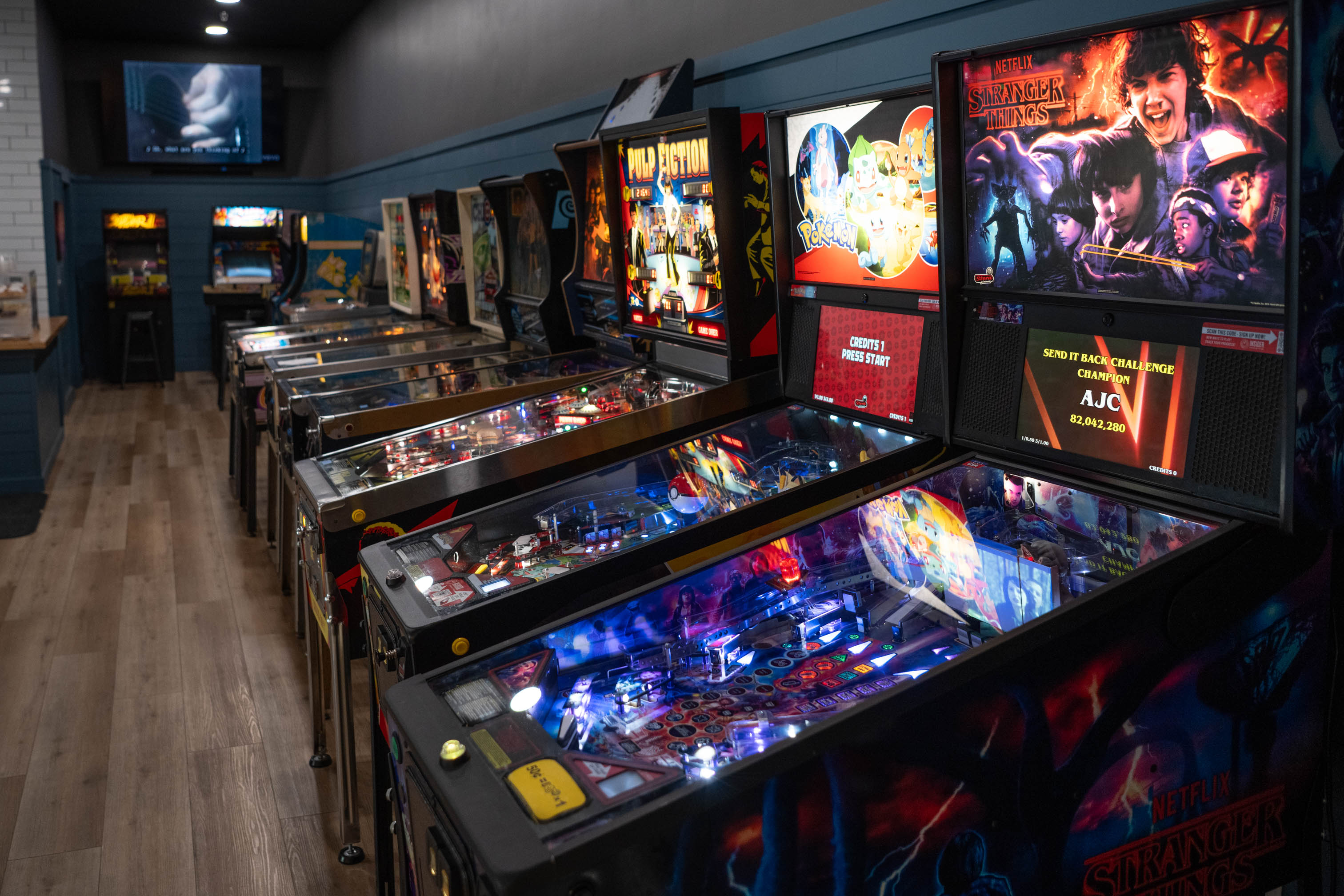 this is a photo of retro pinball machines in a coffee shop setting
