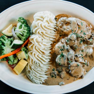 Chicken in a creamy mushroom sauce, served with piped mashed potatoes and steamed veggies.