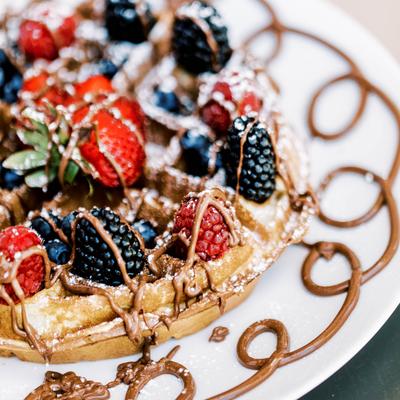 Belgian waffled with mixed berries, Nutella, and powdered sugar.