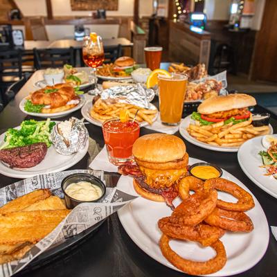 Assortment of dishes served on the table alongside drinks.
