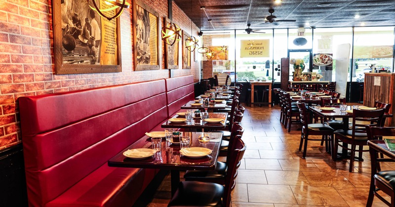 Interior, dining area, long padded banquette bench with wooden tables and chairs