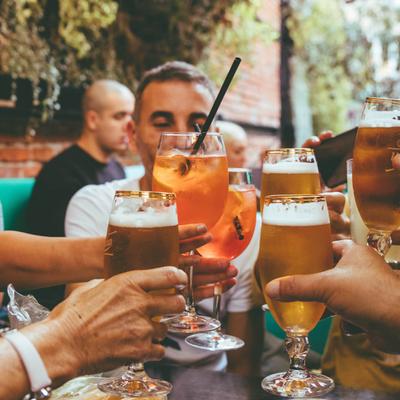 People toasting with beers outside.