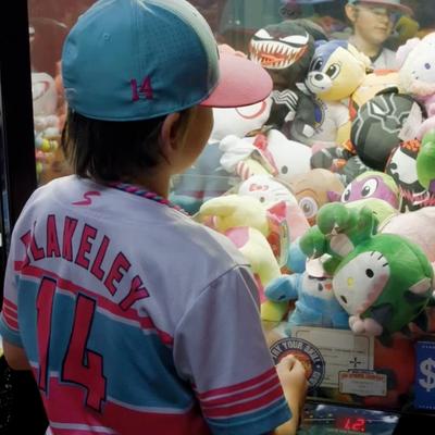 A child next to the claw machine.
