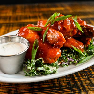 House Smoked Chicken Wings with scallions and dip.