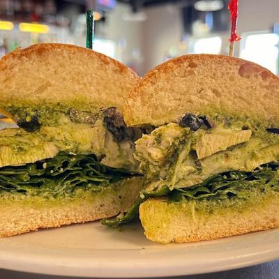 Grilled chicken sandwich, with pesto, baby spinach, pepperoncinis, olives, and provolone.