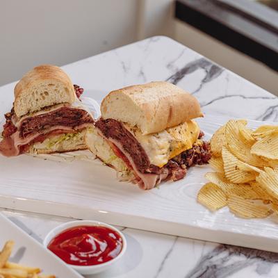 Sandwiches, potato chips, and ketchup dip.