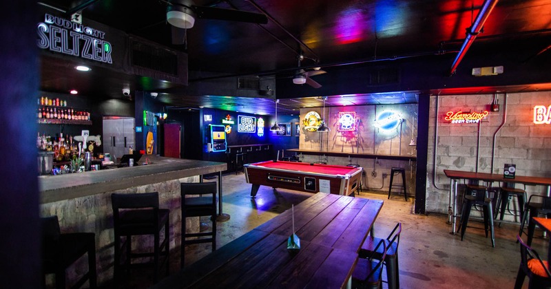 Interior, bar, pool table, tables and seating, neon light signs on walls