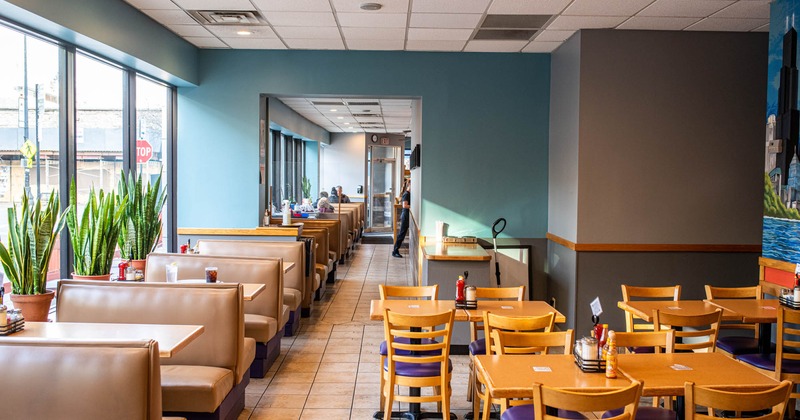 Dining booths and tables, plant pots on the window