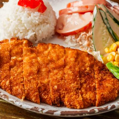 Chicken katsu served with white rice and salad.