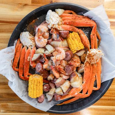 Low Country Boil featuring crab legs, shrimp, sausage, corn and potatoes.
