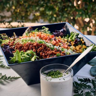 southern spring mix salad with bacon, blue cheese, corn, tomatoes, and buttermilk peppercorn dressing.